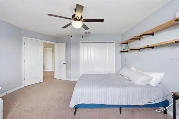 a front view of a house with a big yard and potted plants