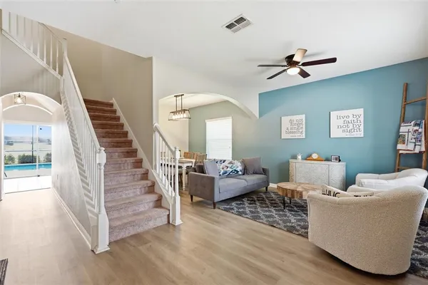 a living room with furniture and a chandelier