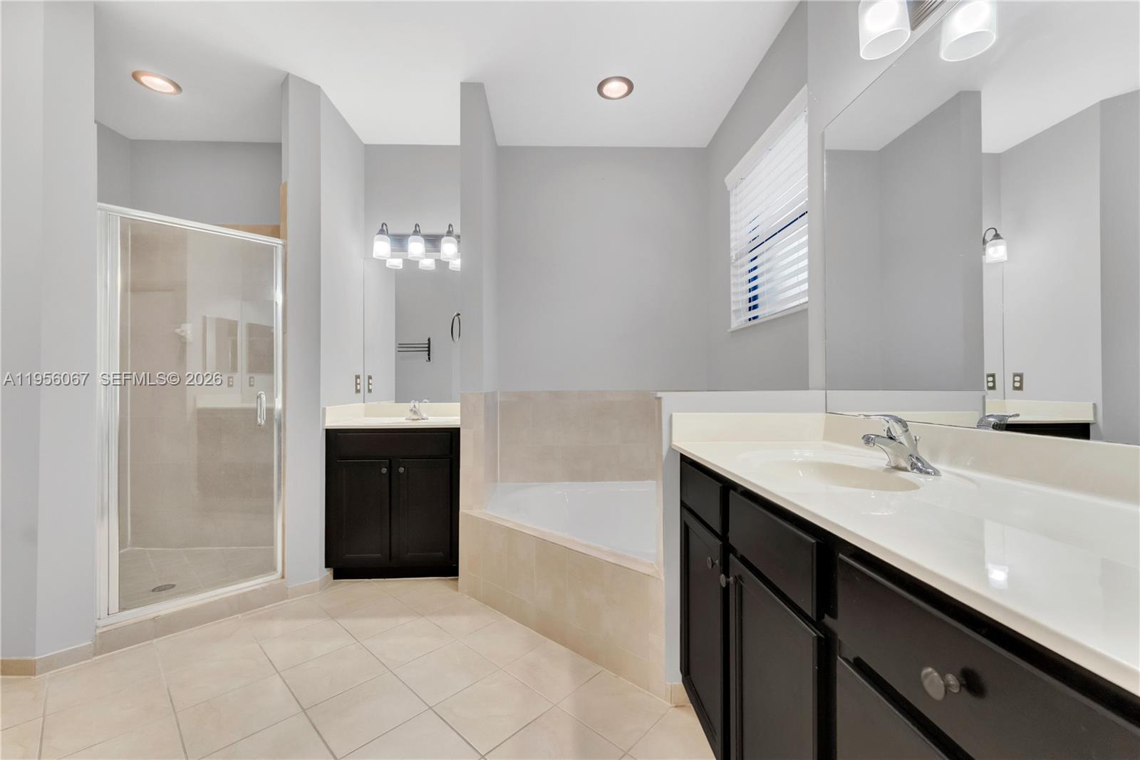 3401 Southeast 5th Street Homestead, FL 33033 - Photo 13 of 32 a spacious bathroom with a bathtub sink and mirror