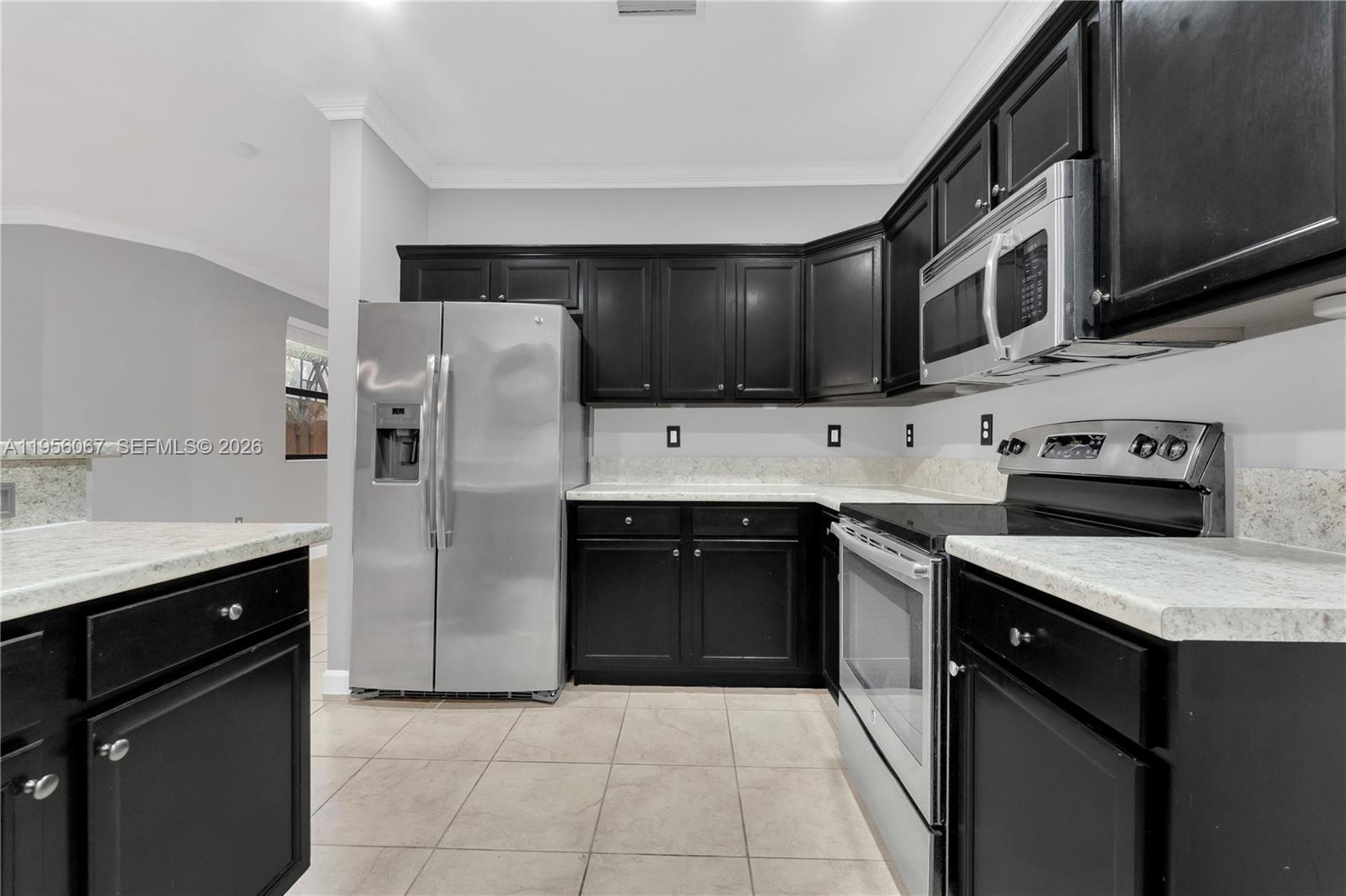 3401 Southeast 5th Street Homestead, FL 33033 - Photo 9 of 32 a kitchen with stainless steel appliances granite countertop a stove a refrigerator and a sink