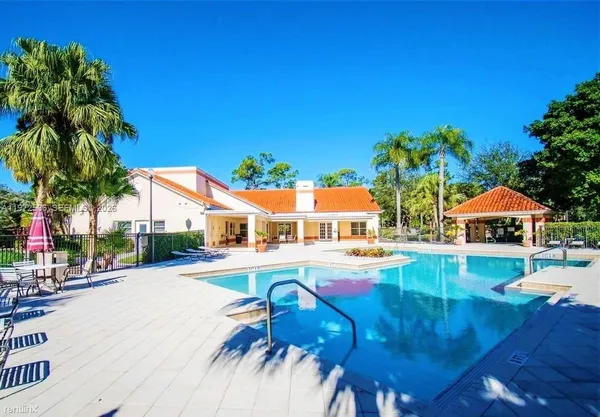 a front view of house with yard and swimming pool