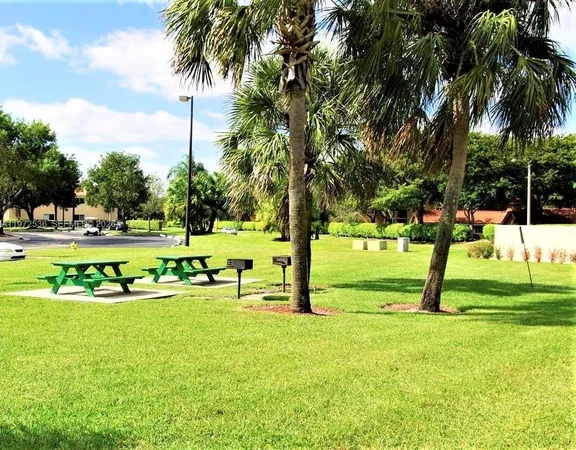 a view of yard with swimming pool and green space