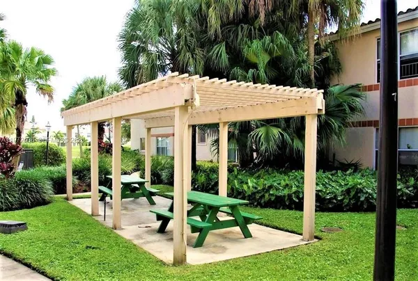 a view of a house with backyard and porch