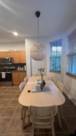 a living room with furniture and a view of kitchen
