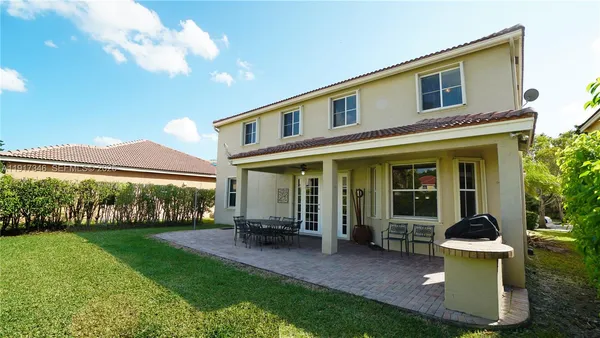 a view of a chair and tables in the patio