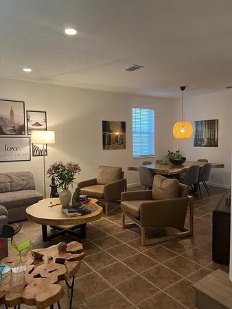 a living room with furniture and a potted plant
