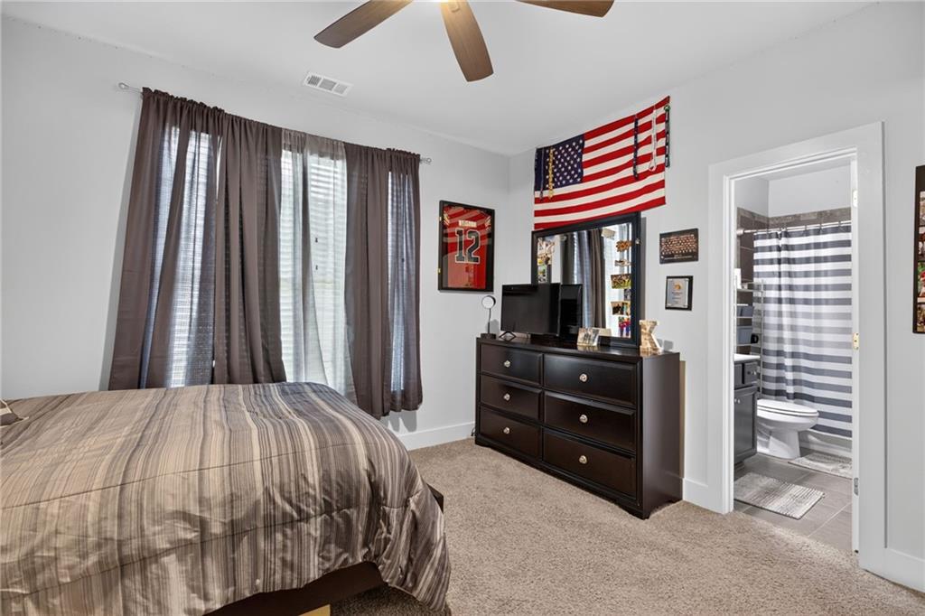 139 Manchester Lane Villa Rica, GA 30180 - Photo 26 of 60 a bedroom with a bed and a chandelier