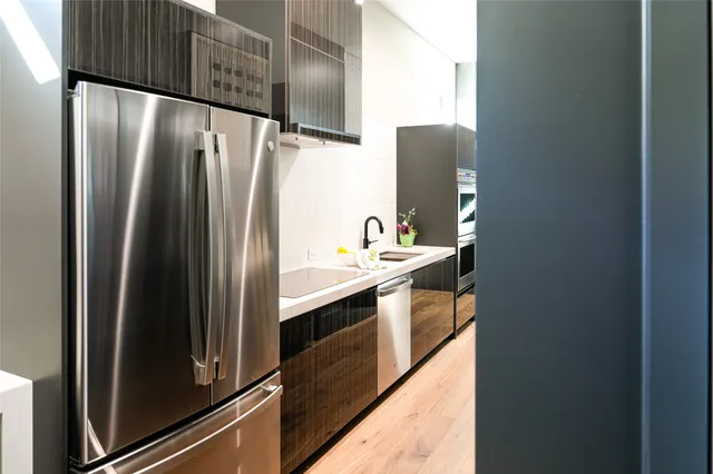 a kitchen with stainless steel appliances a refrigerator and a sink