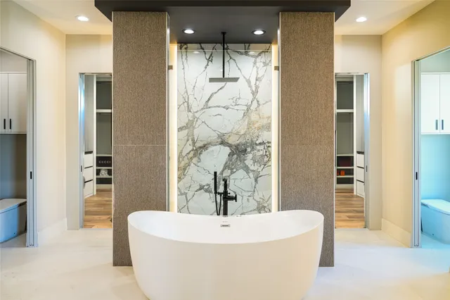 a bathroom with a bathtub and shower