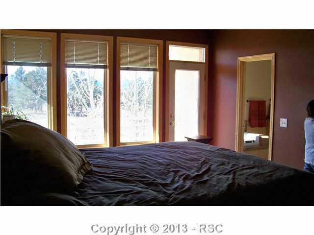16835 Roller Coaster Road Colorado Springs, CO 80921 - Photo 17 of 25 Master Bedroom boasts a private covered balcony-walk in closet-4 piece bath adjoins