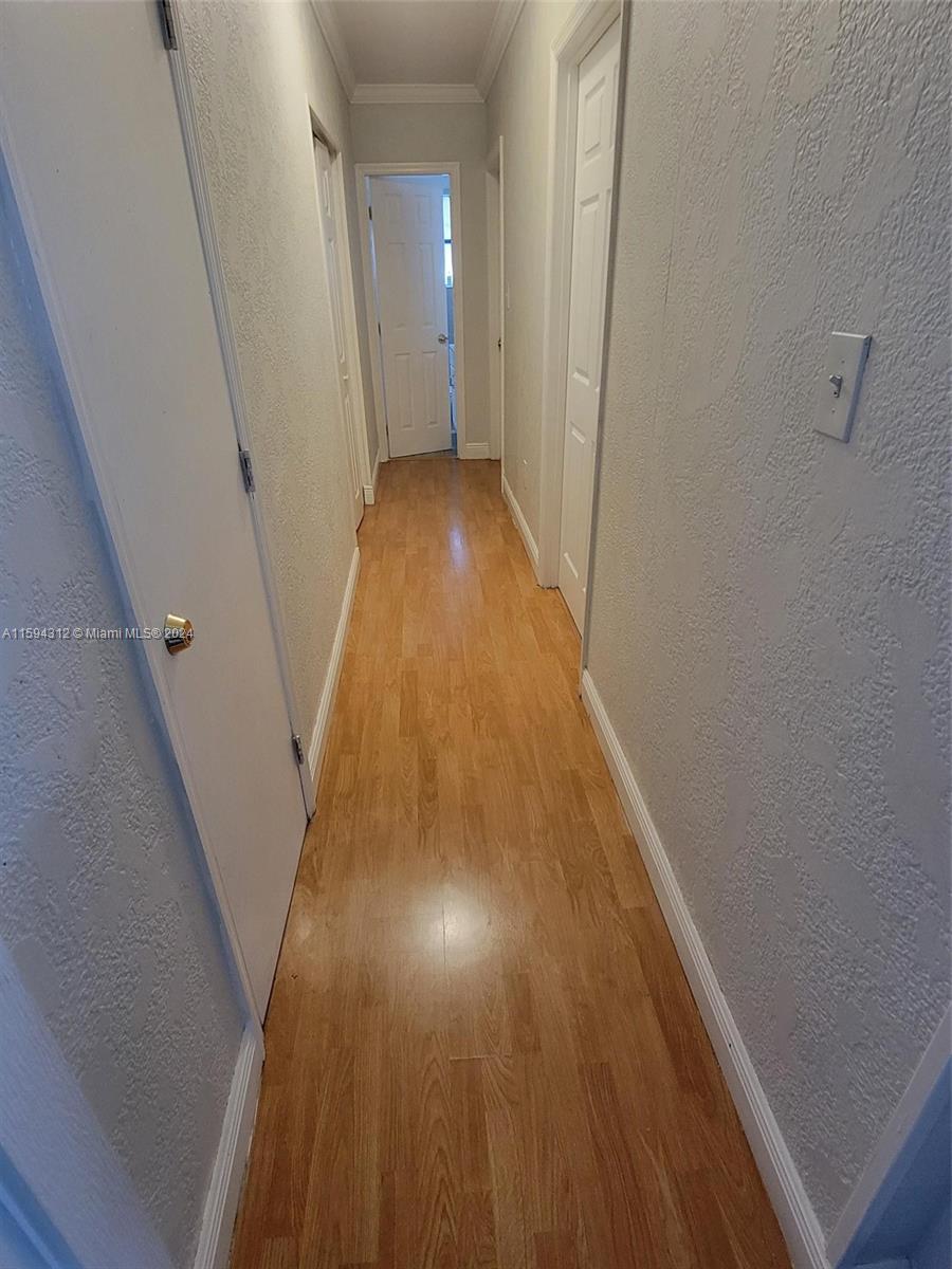 1107 Mayflower Road Fort Pierce, FL 34950 - Photo 17 of 21 a view of a hallway with wooden floor