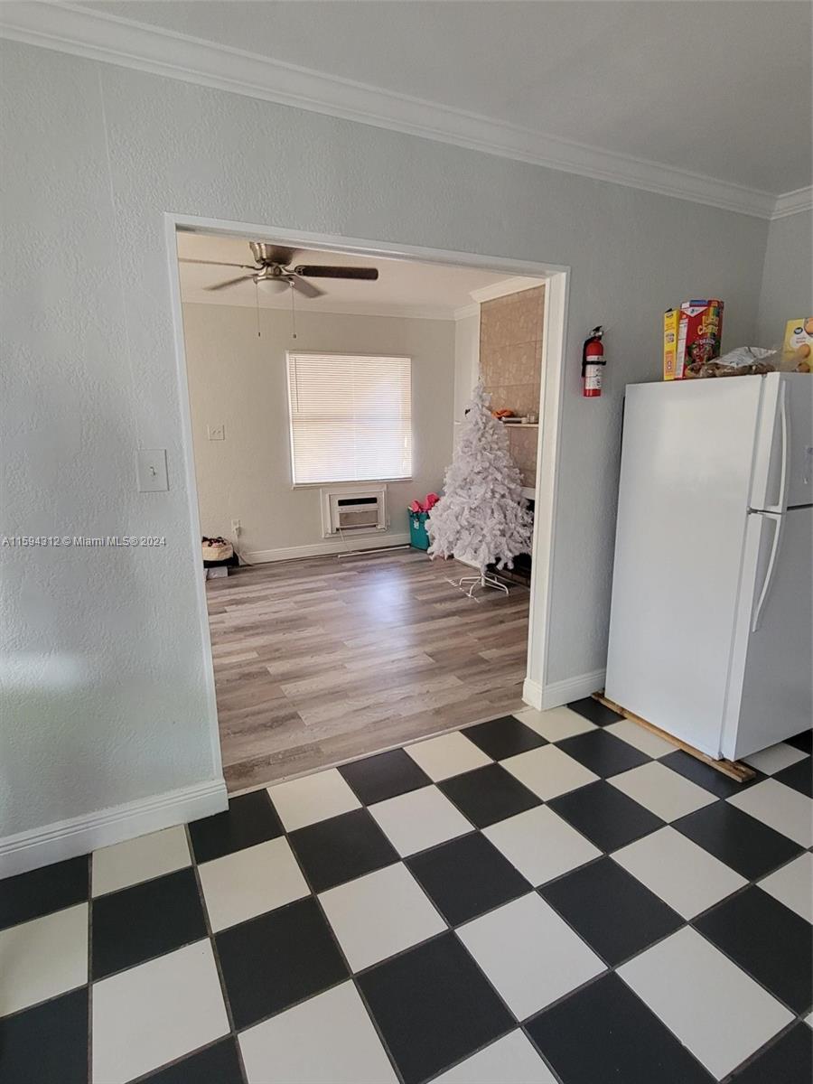 1107 Mayflower Road Fort Pierce, FL 34950 - Photo 20 of 21 a view of a refrigerator and wooden floor