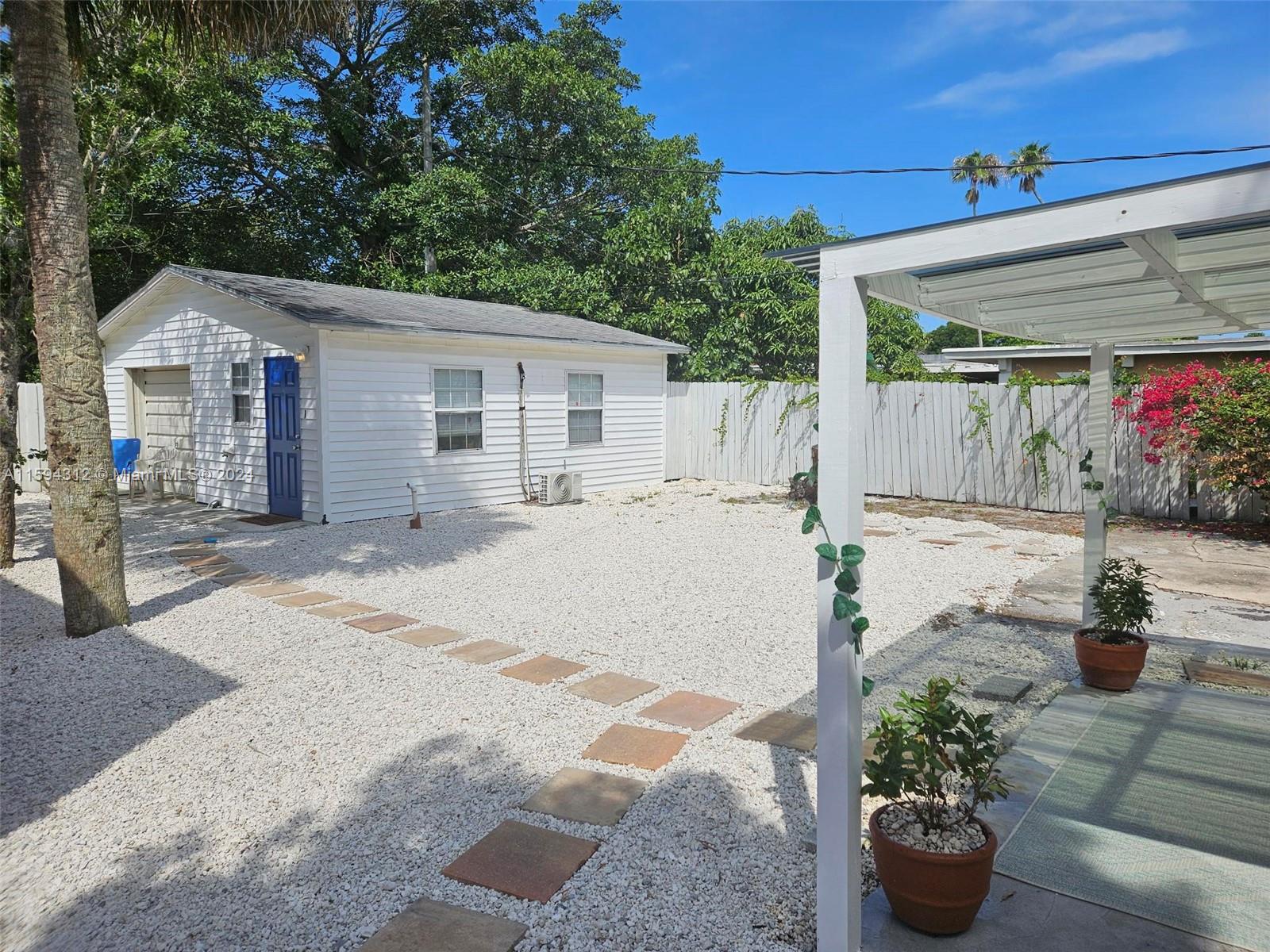 1107 Mayflower Road Fort Pierce, FL 34950 - Photo 5 of 21 a view of a patio with table and chairs potted plants