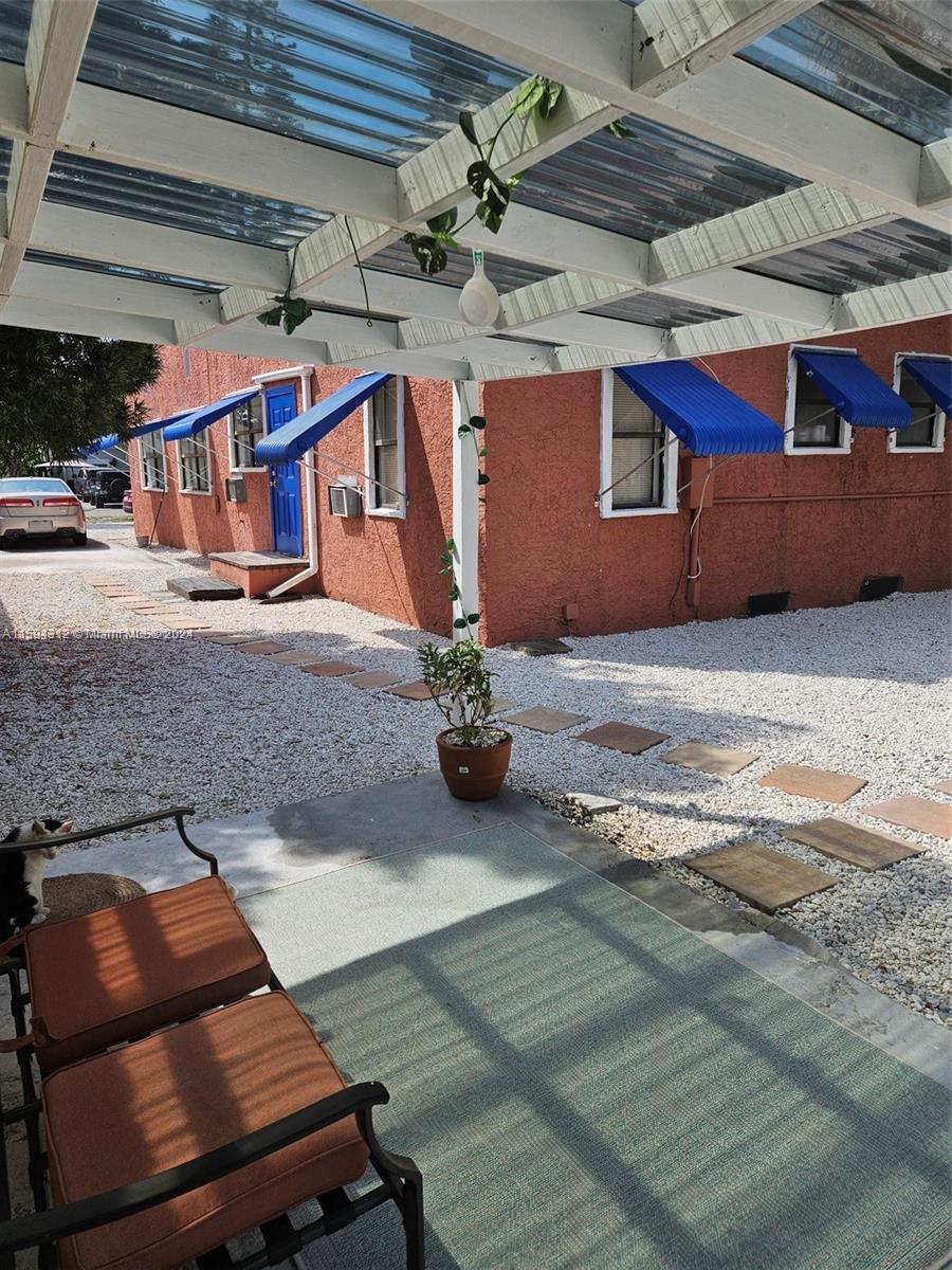 1107 Mayflower Road Fort Pierce, FL 34950 - Photo 8 of 21 a view of a patio with table and chairs with wooden floor