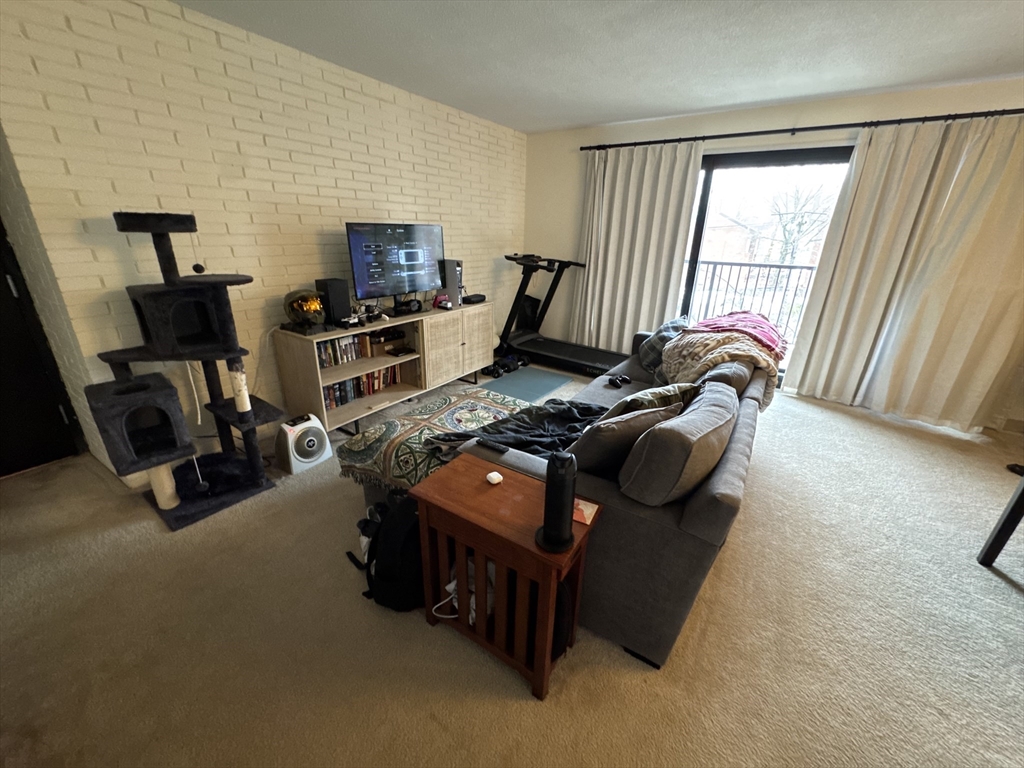 49 Marion Street, Unit 4D Brookline, MA 02446 - Photo 1 of 8 a room with furniture and a window