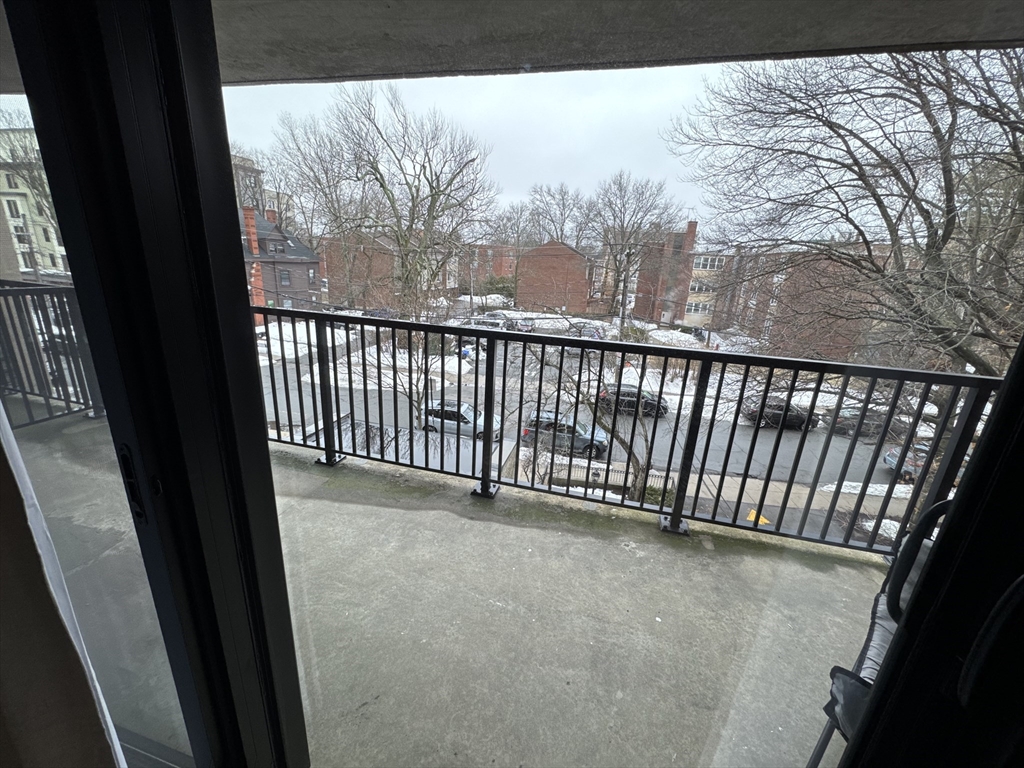 49 Marion Street, Unit 4D Brookline, MA 02446 - Photo 4 of 8 a view of a balcony with wooden fence