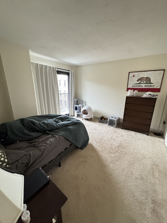 49 Marion Street, Unit 4D Brookline, MA 02446 - Photo 5 of 8 a bedroom with a bed and window