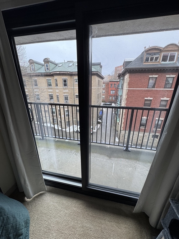 49 Marion Street, Unit 4D Brookline, MA 02446 - Photo 7 of 8 a view of a balcony with a floor to ceiling window
