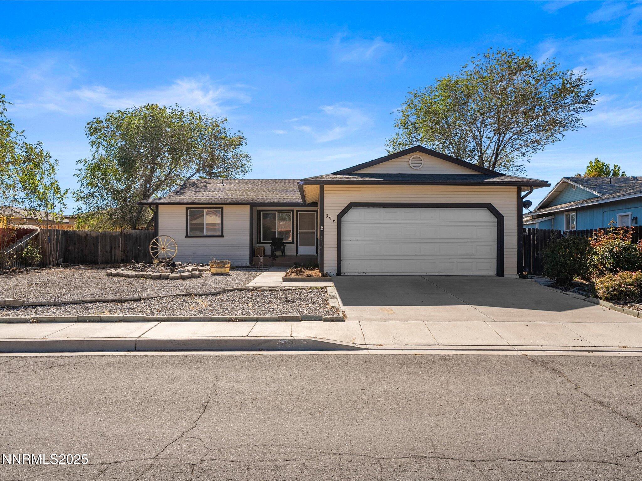 397 Nader Way Fernley, NV 89408 - Photo 1 of 27 a front view of a house with a yard and garage