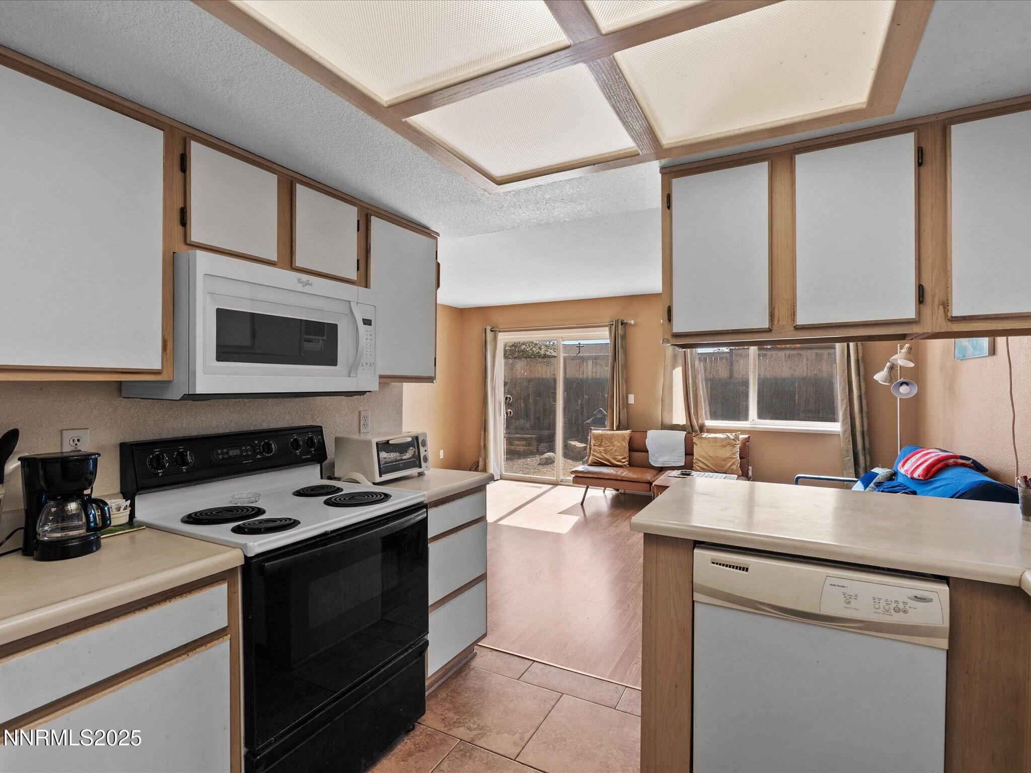 397 Nader Way Fernley, NV 89408 - Photo 12 of 27 a kitchen with a stove a sink and a microwave