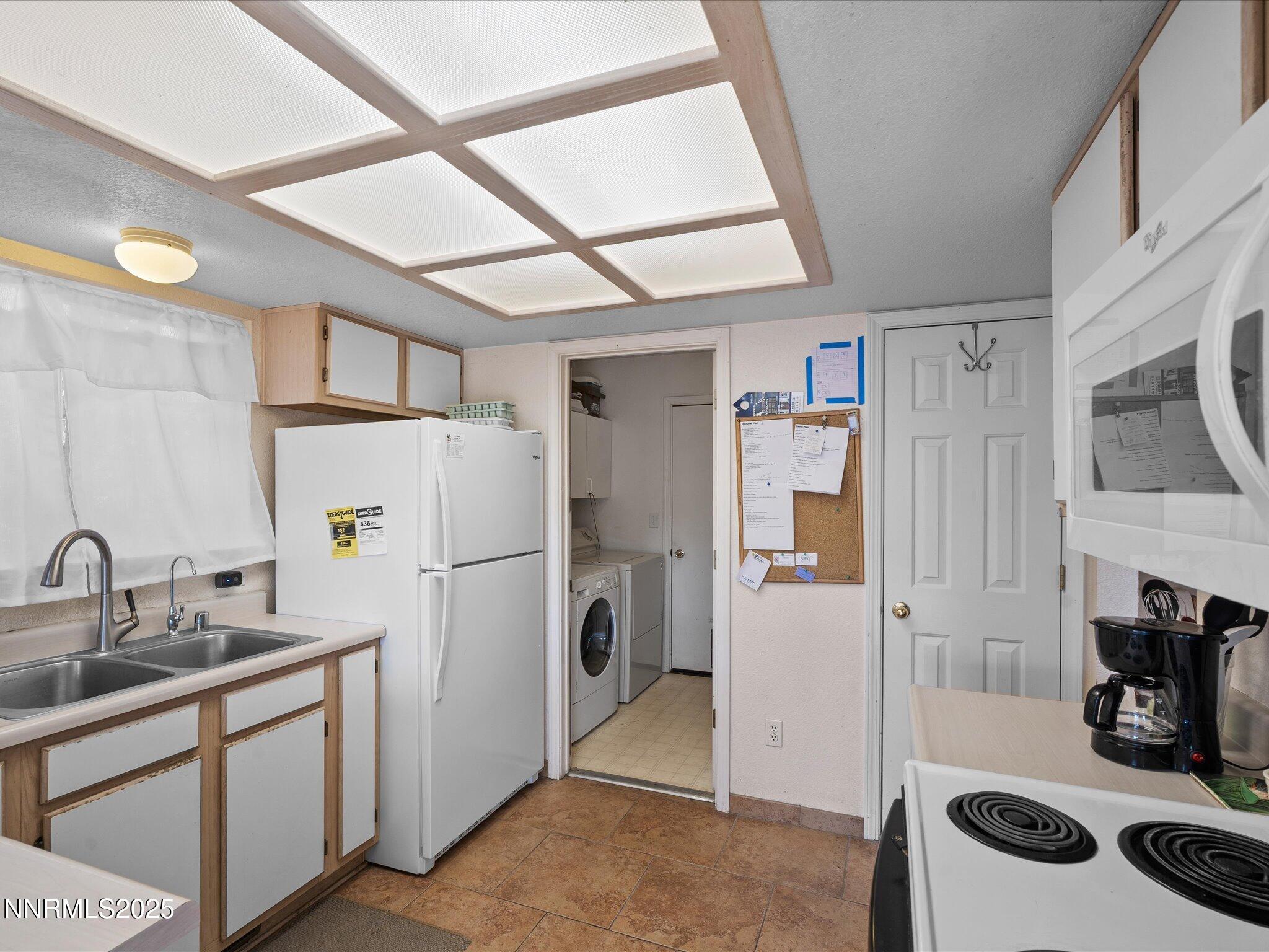 397 Nader Way Fernley, NV 89408 - Photo 14 of 27 a white refrigerator freezer sitting inside of a kitchen