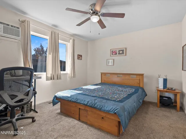 a bedroom with a bed a table and chair