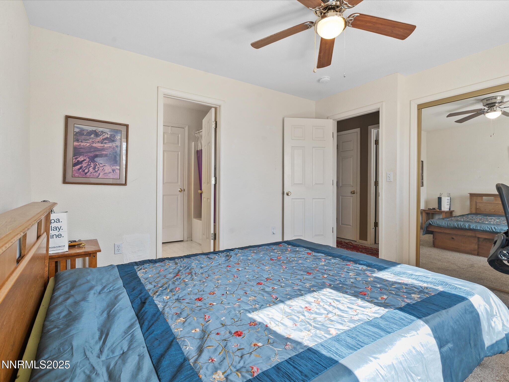 397 Nader Way Fernley, NV 89408 - Photo 22 of 27 a bedroom with a bed and a chandelier