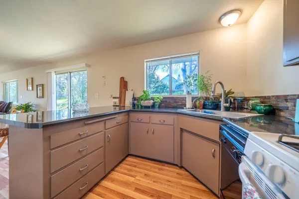 a kitchen with granite countertop stainless steel appliances sink and cabinets