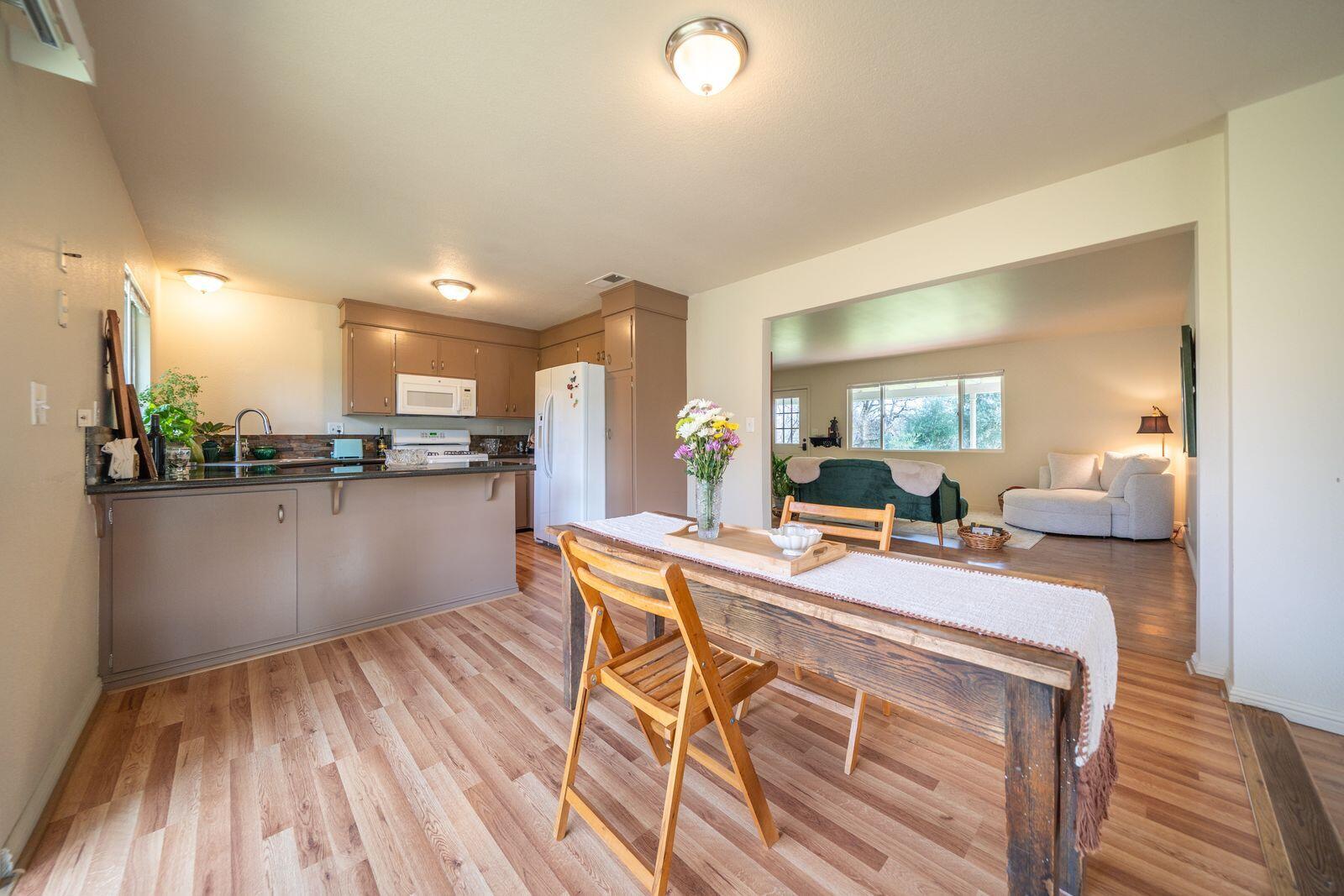 9380 Placer Road Redding, CA 96001 - Photo 16 of 47 a room with stainless steel appliances kitchen island granite countertop a sink and cabinets