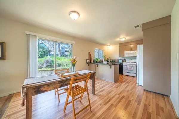 a dining room with furniture and a kitchen view