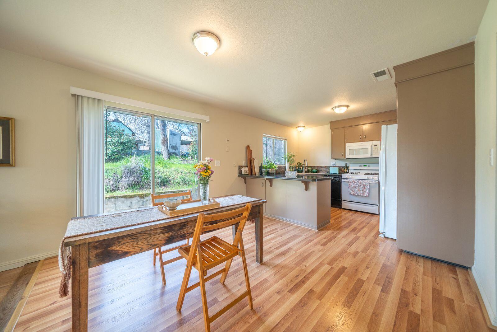 9380 Placer Road Redding, CA 96001 - Photo 18 of 47 a dining room with furniture and a kitchen view