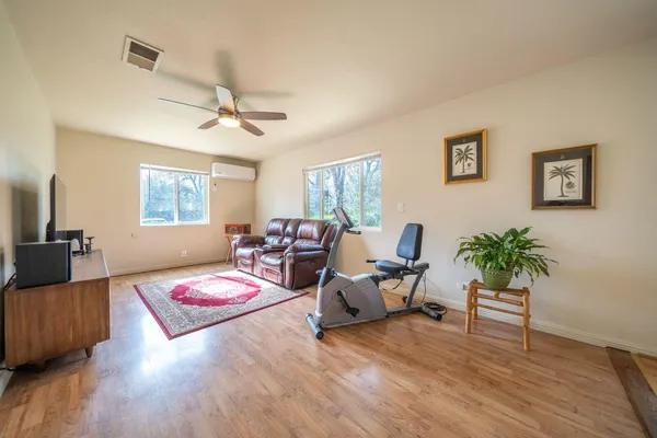 a living room with furniture and a wooden floor