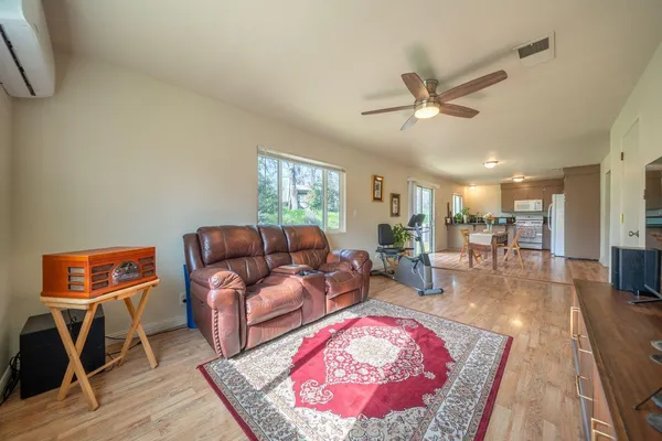 a living room with furniture and wooden floor