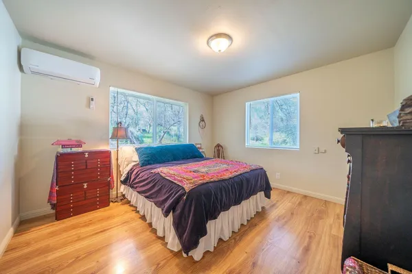 a bedroom with a bed and a painting on the wall