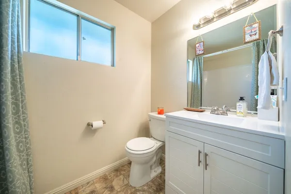 a bathroom with a sink a toilet and a mirror