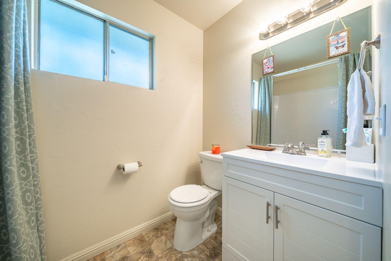 9380 Placer Road Redding, CA 96001 - Photo 23 of 47 a bathroom with a sink a toilet and a mirror