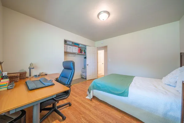 a bedroom with a bed and a desk in it