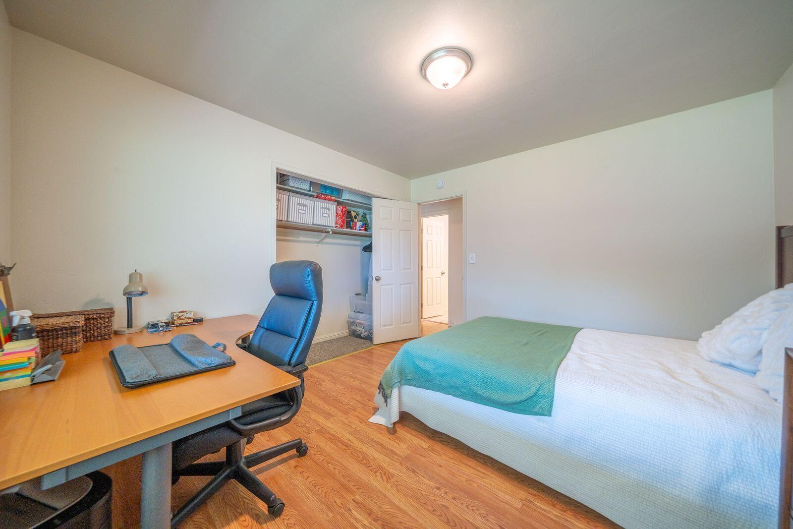 9380 Placer Road Redding, CA 96001 - Photo 25 of 47 a bedroom with a bed and a desk in it