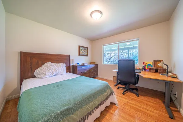 a bedroom with a bed and a desk