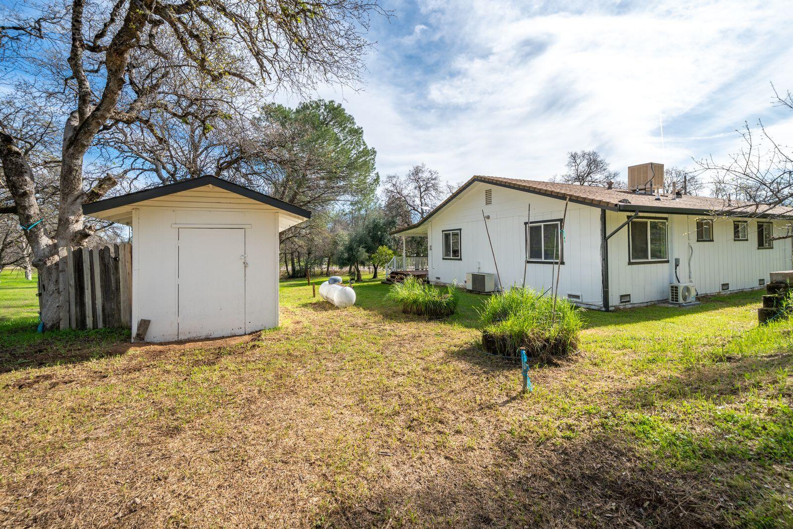 9380 Placer Road Redding, CA 96001 - Photo 32 of 47 a front view of house with yard and trees