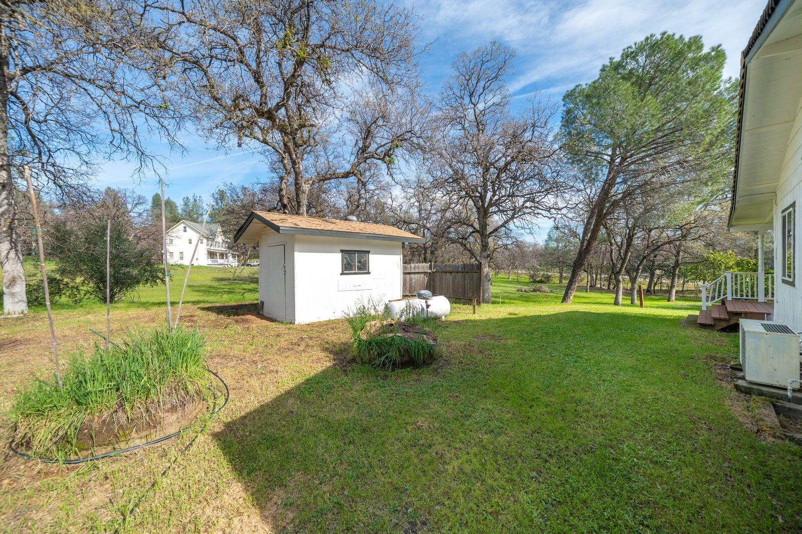 9380 Placer Road Redding, CA 96001 - Photo 33 of 47 a backyard of a house with seating space