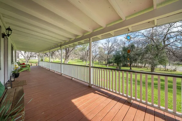 a view of a balcony with wooden floor