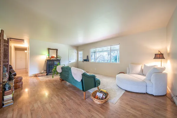 a living room with furniture and wooden floor