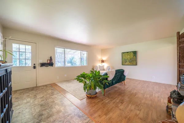 a view of a room with window and wooden floor