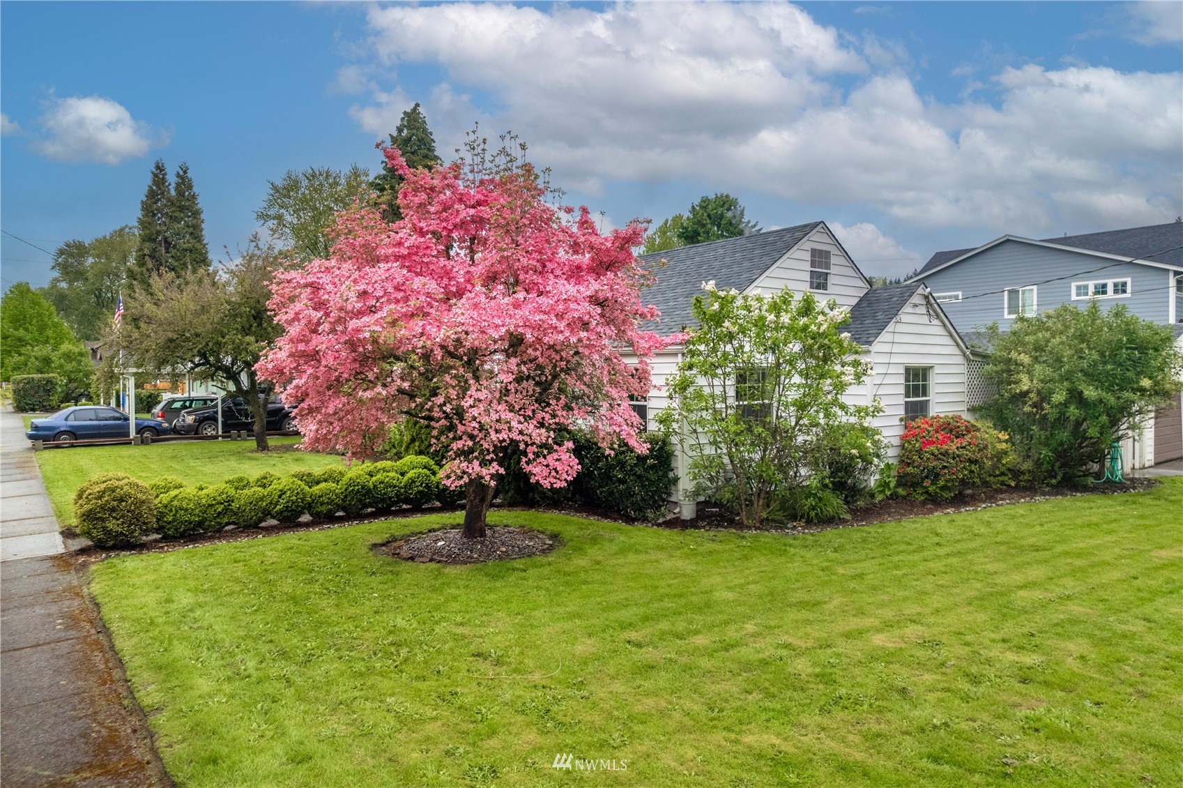 437 State Street Sumner, WA 98390 - Photo 1 of 25 a front view of a house with a yard and fountain in middle
