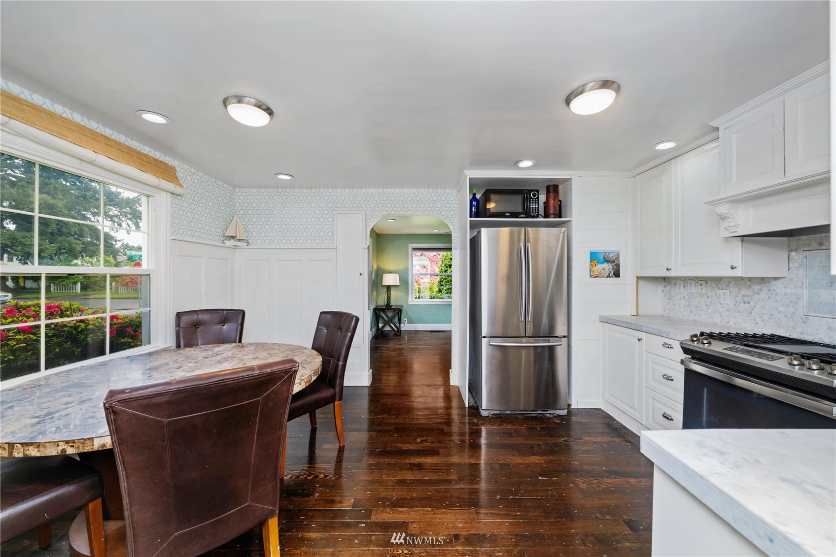 437 State Street Sumner, WA 98390 - Photo 5 of 25 a kitchen with stainless steel appliances granite countertop a refrigerator stove top oven and a dishwasher next to a window