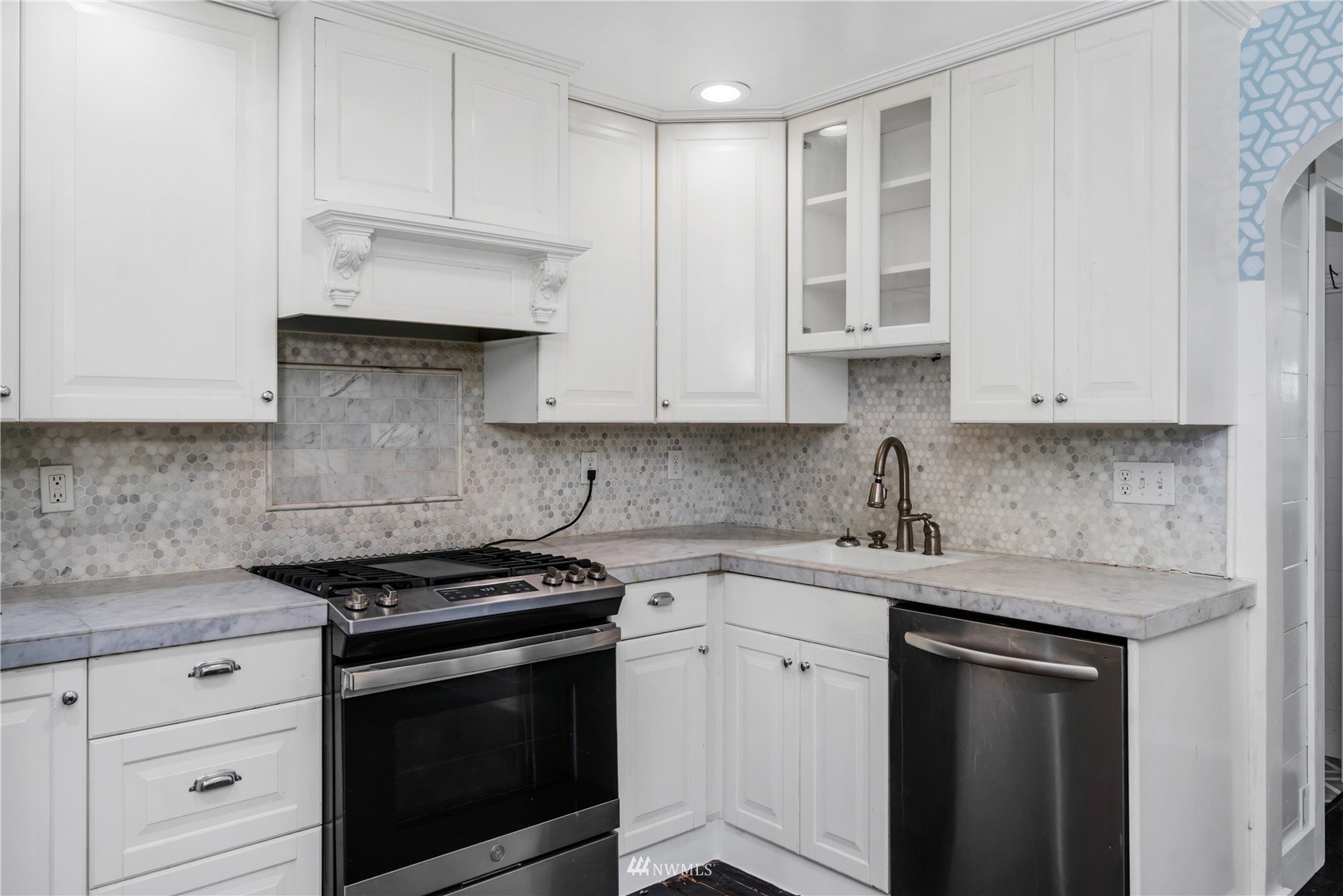 437 State Street Sumner, WA 98390 - Photo 7 of 25 a kitchen with stainless steel appliances granite countertop white cabinets granite counter tops and a wooden floors