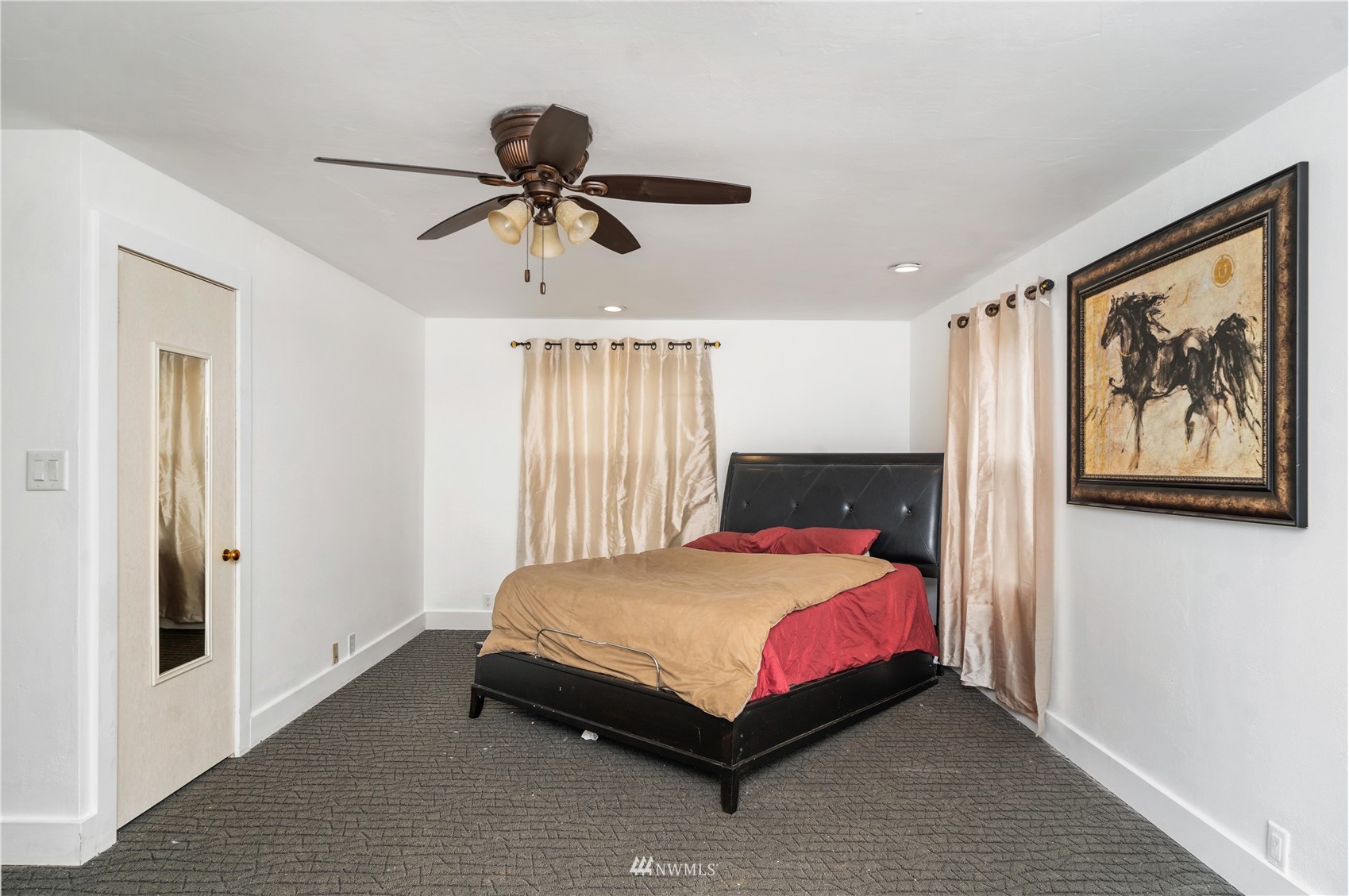 437 State Street Sumner, WA 98390 - Photo 10 of 25 a bedroom with a bed and a painting on the wall
