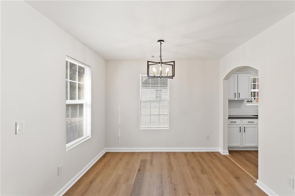 5805 Marbut Road Lithonia, GA 30058 - Photo 12 of 46 wooden floor in an empty room with a window
