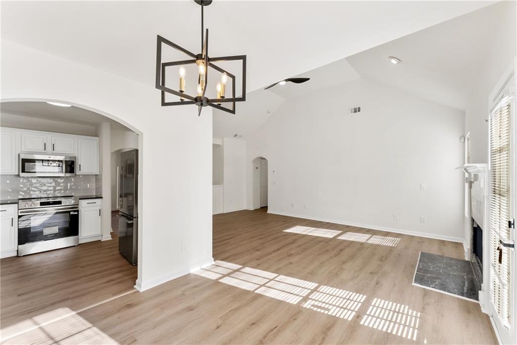 5805 Marbut Road Lithonia, GA 30058 - Photo 13 of 46 a view of a room with a flat screen tv and wooden floor